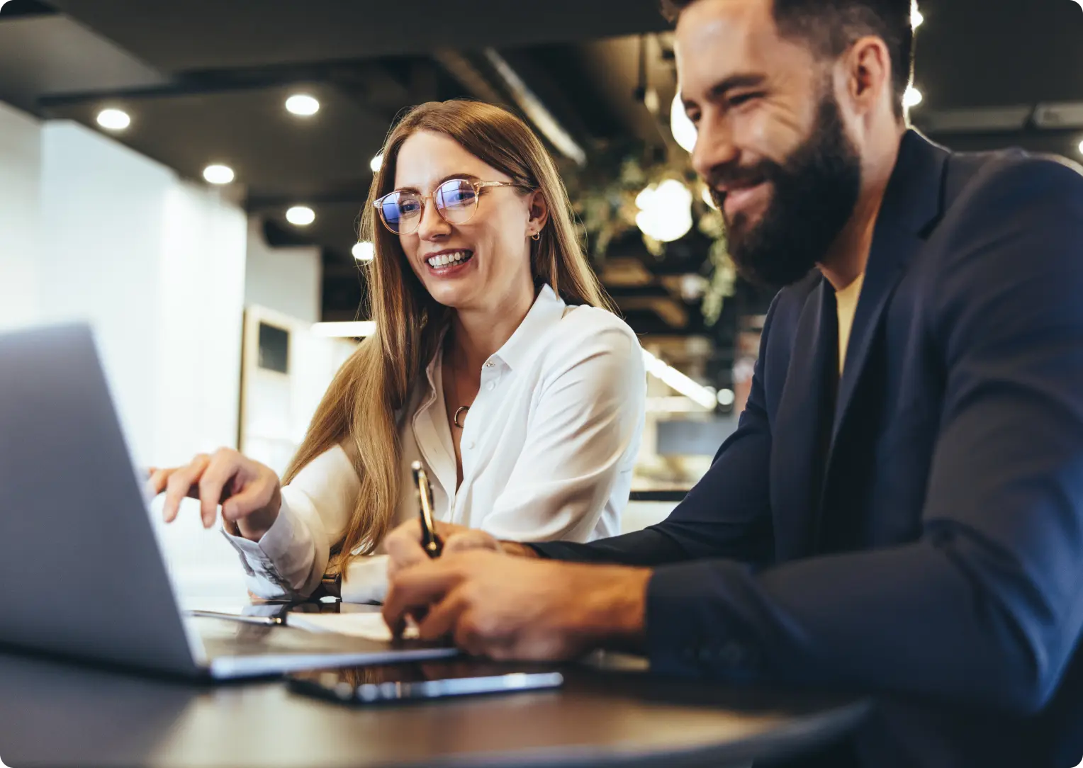 Two people working on a laptop